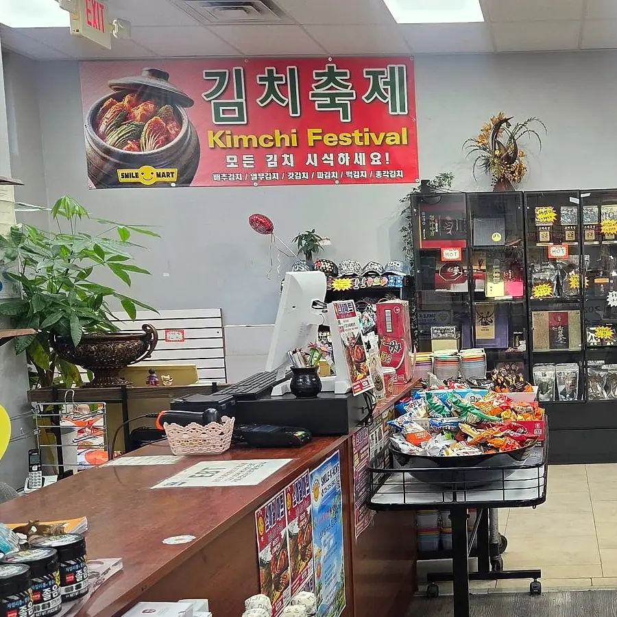 Red Kimchi Festival banner over the counter: “try all our kimchi”