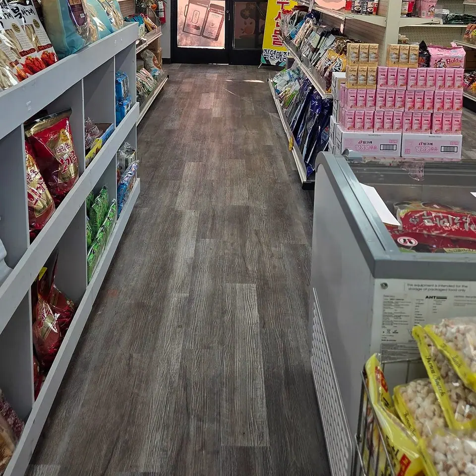 Snack aisle: shelves of Korean snacks and dried fish, stacks of strawberry milk cartons